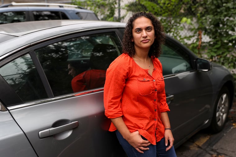 Mary Henin's car was courtesy towed in Philadelphia and then reported stolen when it couldn't be found. It was later found, but remained on the stolen vehicle list, leading to her being stopped and handcuffed until the issue was resolved.