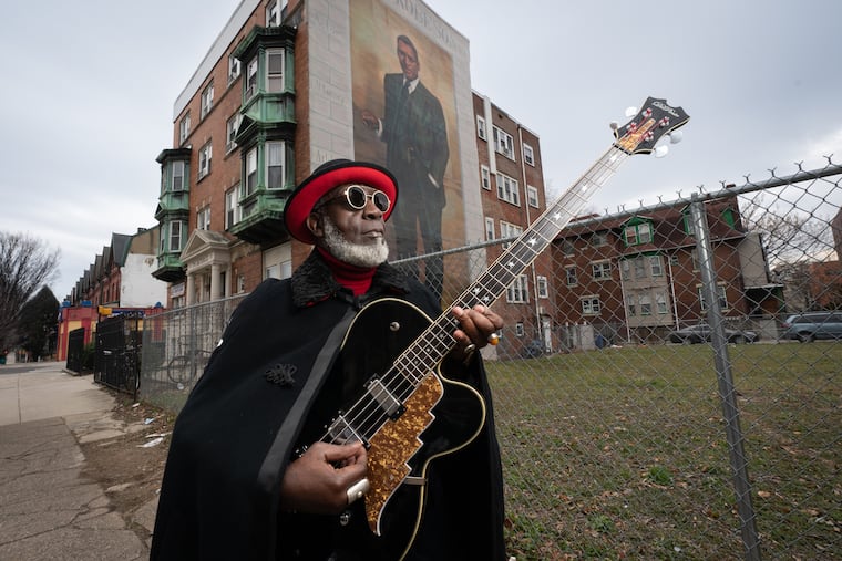 Jamaaladeen Tacuma, a jazz-funk bass player and longtime Philadelphia musician, is shown here on Chestnut Street between 45th and 46th Streets, in front of a Paul Robeson mural, on January 25, 2022.