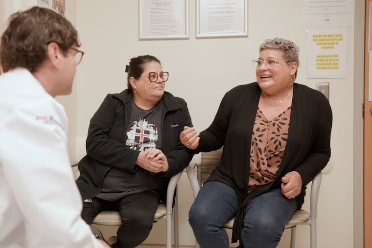 Maria Pascale and her sister Maria Durante sit in an exam room with Rutgers oncologist Christian Hinrichs.