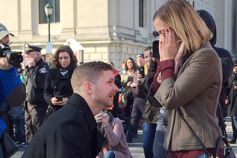 Amy MacCord said, "Yes!" after seeing a marching band approaching with the drum majors carrying a banner that read, "Amy, will you marry me?"