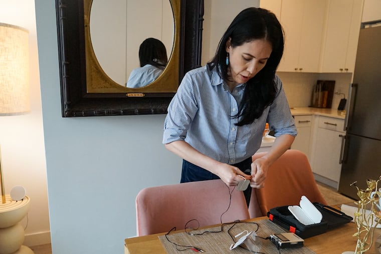 Sophia Bassan has endured post-mastectomy pain syndrome, estimated to affect thousands of U.S. women each year. With no clear treatment, Bassan and others have experimented with options such as the nerve stimulation machine pictured here. (Amy Maxmen/KFF Health News)