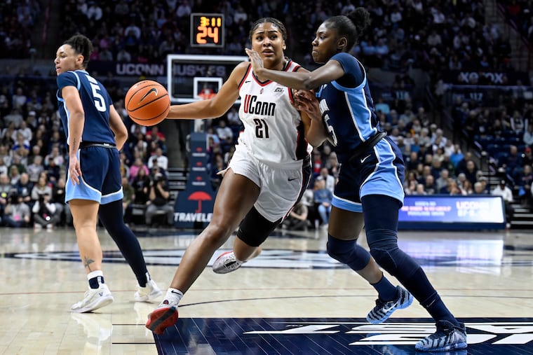 UConn forward Sarah Strong (21) drives to the basket as Villanova forward Denae Carter defends in the first half on Thursday in Storrs, Conn.