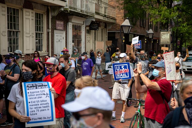 Postal workers and community members rally to save the U.S. Postal Service Saturday in front of the historic Benjamin Franklin Post Office on Market Street in Old City.