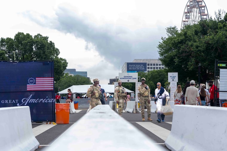 National Guard members stand at the entrance of the Great American State Fair on the National Mall, Saturday June 27, 2026, in Washington.