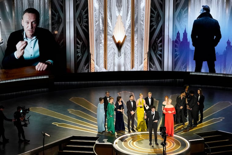 Daniel Roher and the members of the crew from "Navalny" accept the award for best documentary feature film at the Academy Awards on Sunday at the Dolby Theatre in Los Angeles.