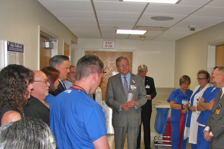 Joseph Devine, president of Jefferson — NJ, talks with some of his staff.