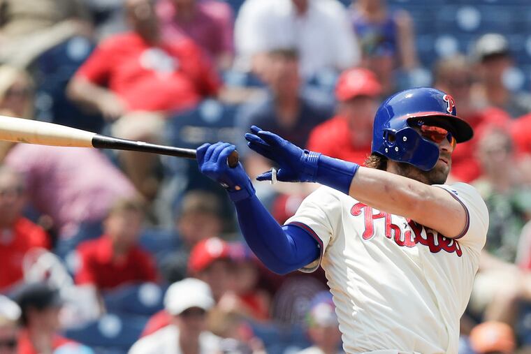 Phillies Bryce Harper bats against the San Diego Padres on Sunday in Philadelphia.