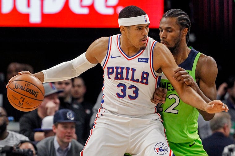 Sixers' forward Tobias Harris backs down Timberwolves wing Andrew Wiggins on Saturday.
