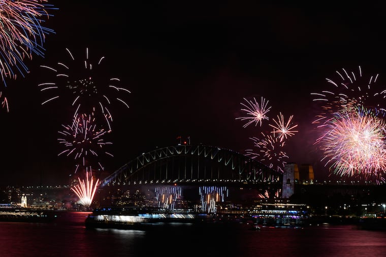 Fireworks burst over the Sydney Harbour Bridge as New Year's celebrations begin in Sydney.