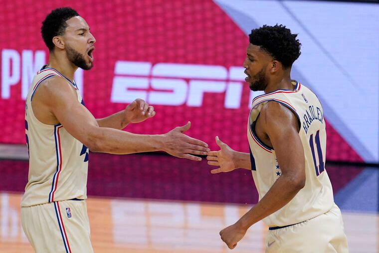 Sixers guard Ben Simmons celebrates with center Tony Bradley (11) during the second half.