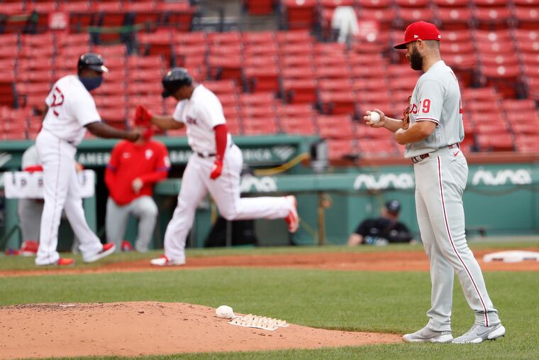 Boston's Rafael Devers rounds third base after hitting a two-run home run in the third inning off Phillies pitcher Jake Arrieta Wednesday at Fenway Park.