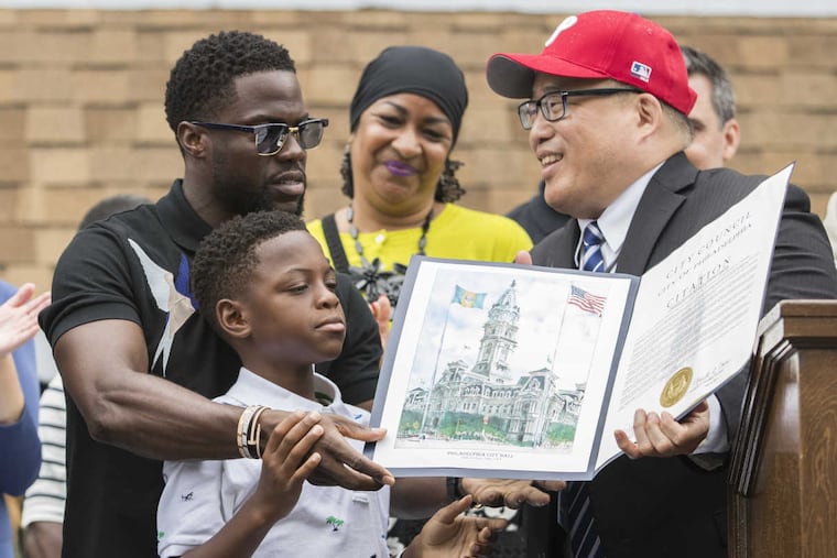 Kevin Hart and his son Hendrix receive proclamation from Councilman David Oh on Kevin Hart day in Philadelphia.