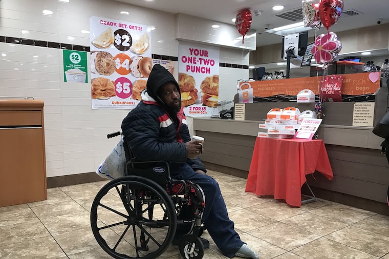Kenny Solomon, 46, sits at the Dunkin' Donuts at Suburban Station where he encountered police Tuesday night.