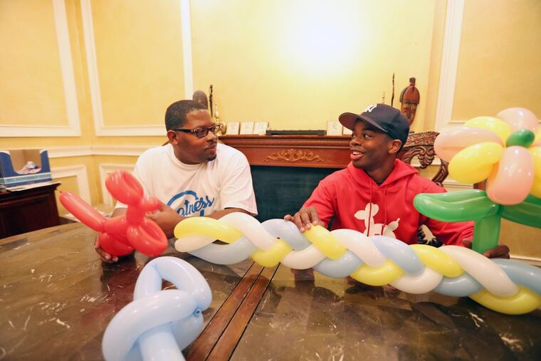 Local balloon artist Brian Ward and his father in the dining room of their Philadelphia home Tuesday November 14, 2017. DAVID SWANSON / Staff Photographer
