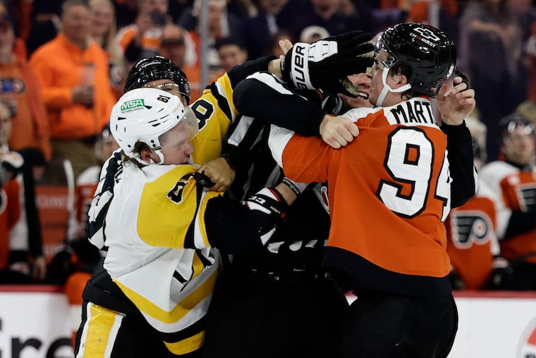 The Flyers' Porter Martone and Pittsburgh Penguins center Ben Kindel fight at the end of Game 3.