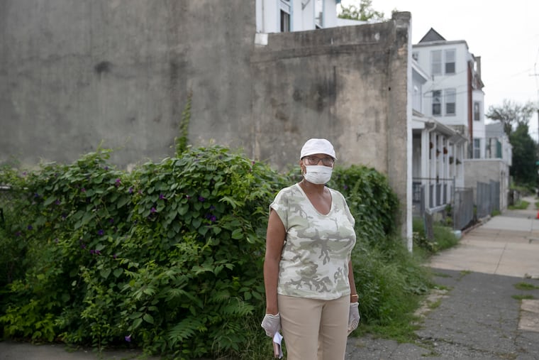 Lynda White poses for a portrait near an empty plot of land on Queen Lane and Morris St. in Germantown on Friday, Aug. 14, 2020. Residents like White have been active in trying to find public space for a playground for children in the neighborhood.
