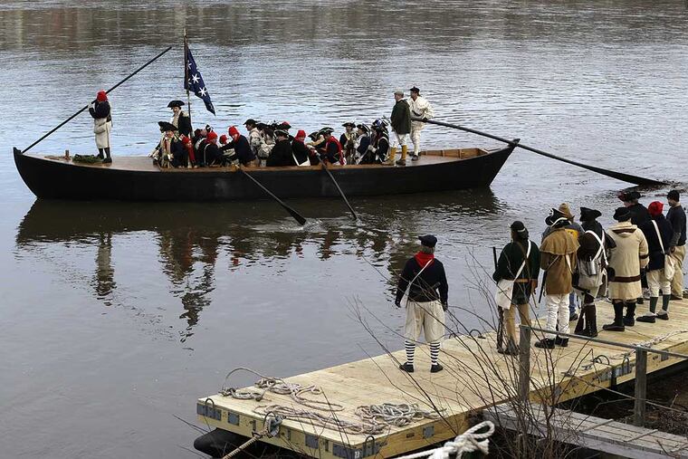 A boat chugs along the Delaware River on its way from Pennsylvania to New Jersey during the 61st annual re-enactment of Washington's daring Christmas 1776 crossing of the river, the trek that turned the tide of the Revolutionary War, in Washington Crossing, N.J., on Wednesday, Dec. 25, 2013. During the crossing 234 years ago, boats ferried 2,400 soldiers, 200 horses and 18 cannons across the river, and the troops marched eight miles downriver before battling Hessian mercenaries in the streets of Trenton. (AP Photo/Julio Cortez)