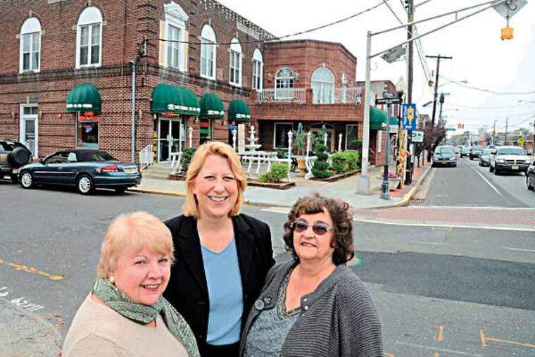 Maple Shade is set to celebrate its 325th anniversary with a gala at Cafe Fontana (building in the background) which used to be the municipal building, fire house, courthouse and jail. Organizing the celebration are (from left): Betty Procopio, Pres. of the Historical Society of Maple Shade; Ellen McDowell, Pres. of Main St. Maple Shade, Inc.; and Joanne Mortimer, ex. dir. of Main St. Maple Shade Inc. The ladies are standing at the intersection of E. Main St. and Maple St. Oct. 31, 2013. ( CLEM MURRAY / Staff Photographer )