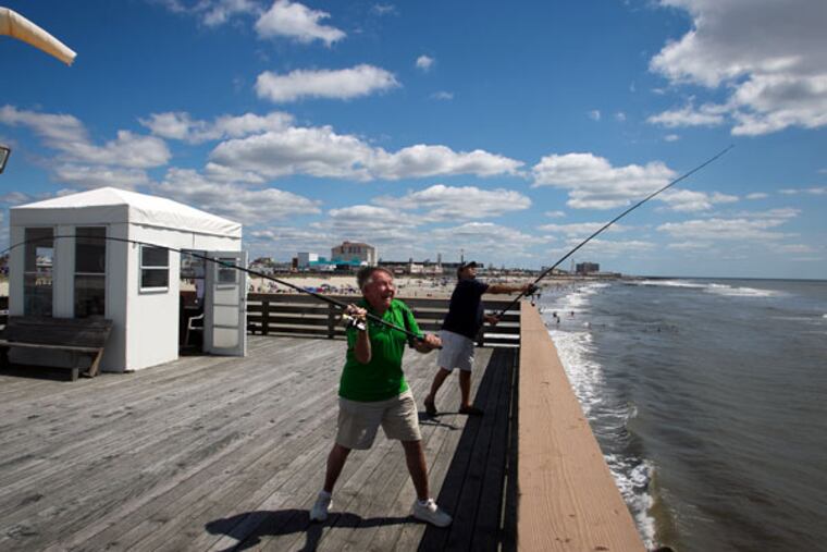 Bob Roth and Frank Pizzutilla cast their lines on Monday from the Ocean City Pier. Both are members of the Ocean City Fishing Club. (ALEJANDRO A. ALVAREZ/STAFF PHOTOGRAPHER)