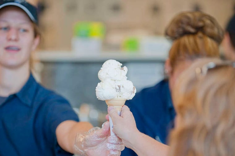 Student serves cone at Berkey Creamery, Penn State. (Penn State photo)