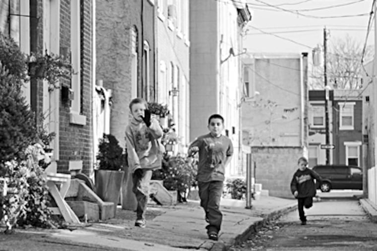 Nov. 21, 2009: Gordon Street, Fishtown; Michael Locke, 9, Timothy Chase, 7, and Kyle Locke, 7, run down the street they helped to clean up. KRISTON J. BETHEL / Staff