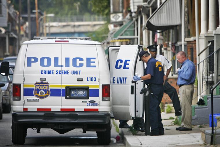 Philadelphia police crime scene unit officers investigate an early morning shooting on the 100 block of Dearborn Street early Thursday morning. Police shot and injured a man who had allegedly shot another person at this same location.
