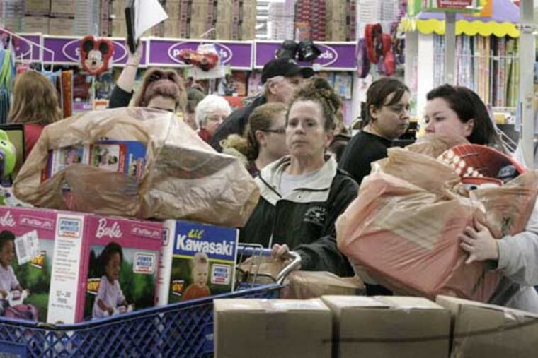 Shoppers wait to check out at a Toys R Us in Deptford, N.J., on Black Friday 2010.