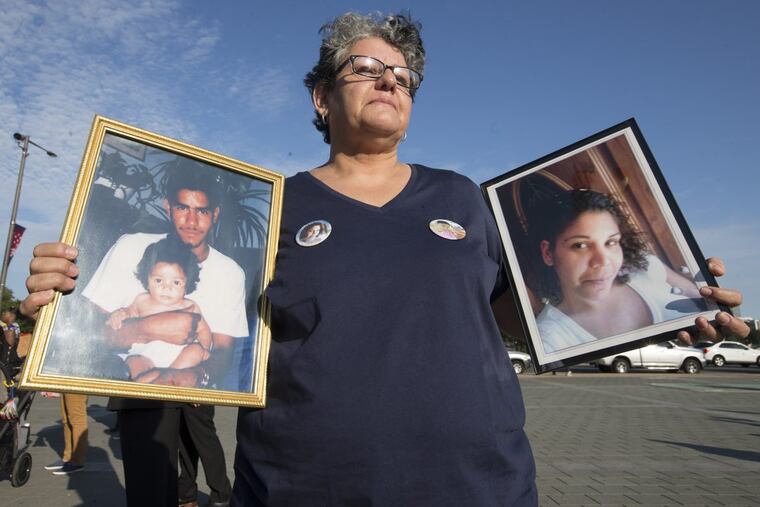 Silvia Barreto holds photos of her children, both victims of fatal gunshots. Her son, Andre Reyes, left, died 20 years ago. Her daughter, Cristina Tosado, was fatally shot in Feb. Relatives and friends of the victims of gun violence stand on the Art Museum steps on June 15, 2017. CHARLES FOX / Staff Photographer