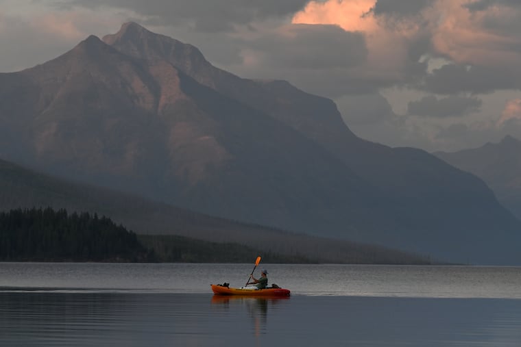 A boater floats on Lake McDonald in Glacier National Park in Montana.