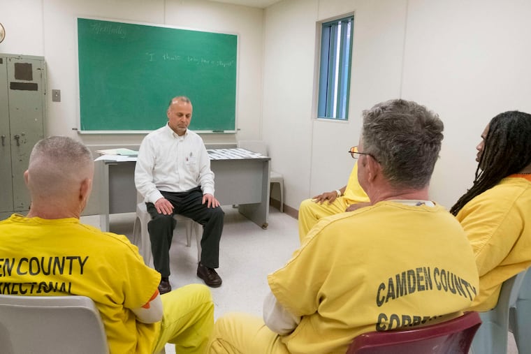 Stephen Michael Tumolo starts a session at the Camden County jail with moments of meditation.