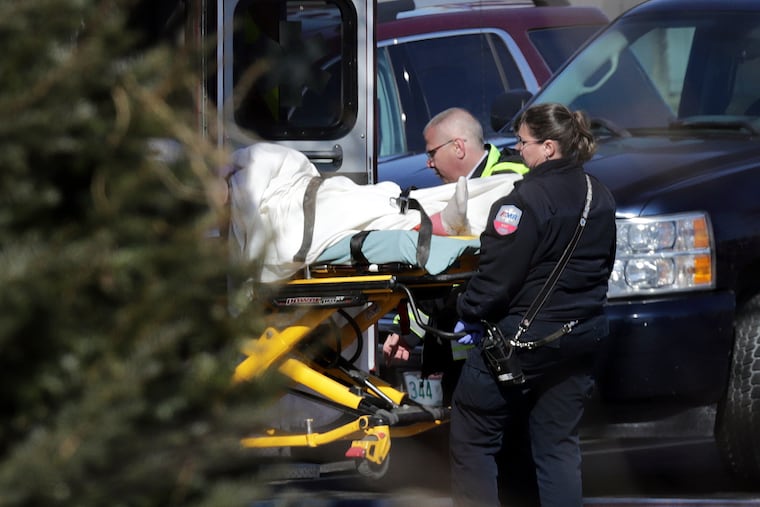 Emergency medical technicians carry a person on a stretcher into an ambulance outside the Quality Inn on Thursday, March 28, 2019, in Manchester, N.H. Two people had barricaded themselves in a first-floor room after one man was shot and killed there Wednesday night by police after he engaged Drug Enforcement Administration agents and police. (AP Photo/Charles Krupa)