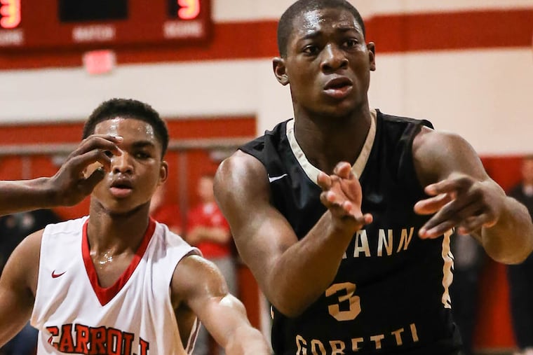 Neumann-Goretti's Zane Martin throws a pass in front of Archbishop Carroll's Josh Sharkey in the fourth quarter.