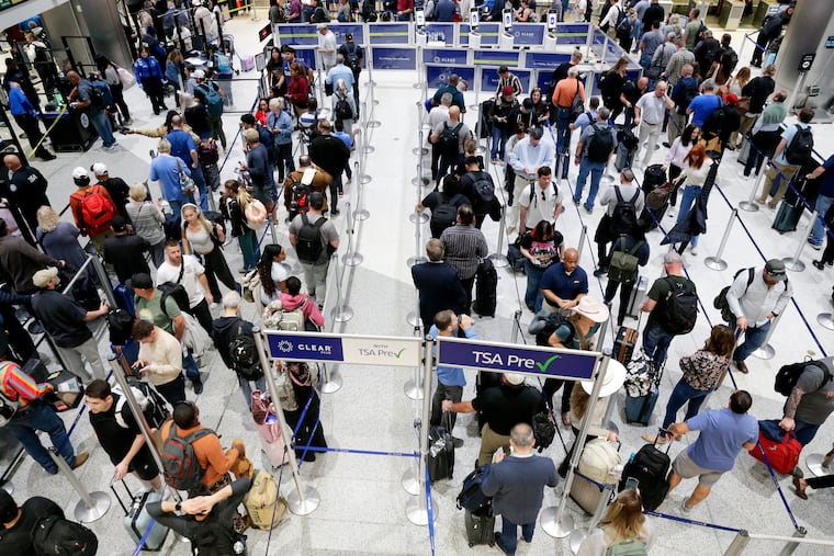 Air travelers progress through the long lines for the TSA security checkpoint in Terminal C at the George Bush Intercontinental Airport, Monday, March 23, 2026, in Houston.