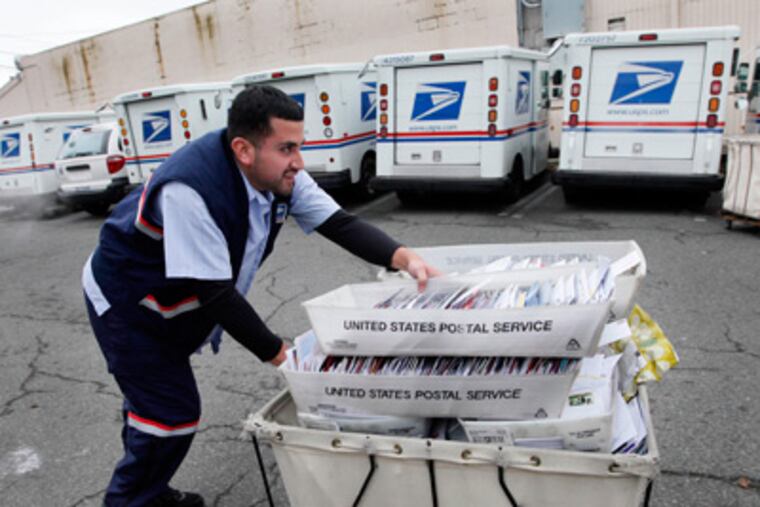 Letter carrier Felipe Raymundo moves a cart of mail to his truck to begin delivery Monday, Dec. 5, 2011, at a post office in Seattle. The cash-strapped U.S. Postal Service said Monday it is seeking to move quickly to close 252 mail processing centers and slow first-class delivery next spring, citing steadily declining mail volume. (AP Photo/Elaine Thompson)