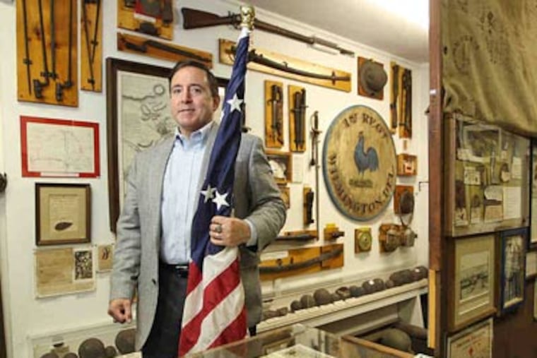 Gene Pisasale among artifiacts at the Christian C. Sanderson Museum, whose holdings include unexploded Civil War munitions. (Michael Bryant / Staff Photographer)