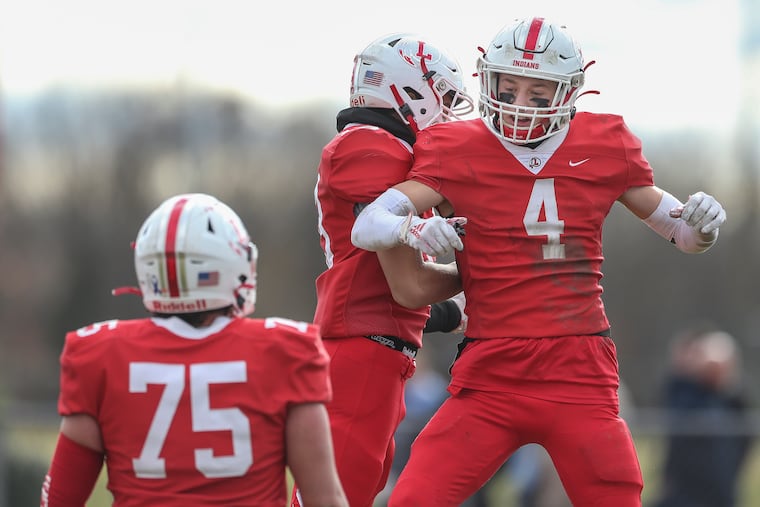 Lenape's Connor Kennedy (4) bumps in the air with a teammate after scoring against Shawnee in the rival schools' annual Thanksgiving Day game on Thursday.