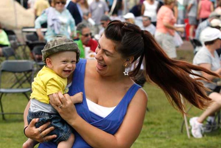 As a band plays, Victoria Spulock dances with her son Andrew, during Long Beach Island's "LBI Thank You Fest." The celebration was for 194 agenices, including the National Guard and Louisiana State Police that helped after Superstorm Sandy. June 15, 2013. MICHAEL S. WIRTZ / Staff Photographer.