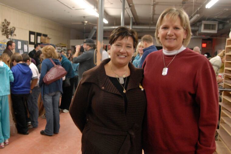 Janet Manion (left) and Nancy Umbrell at Katia McGuirk's tile studio, where work on Freedom Square goes on. The two women grew close after their sons were killed in Iraq. "I hope it makes the next generation understand the service they can offer," Manion said of the project.