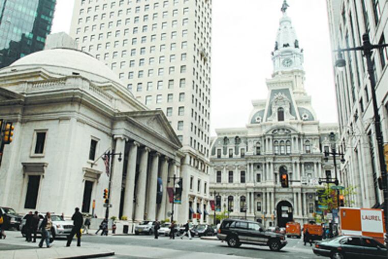 The Ritz-Carlton Hotel (right) with City Hall in the background, got a $400,000-a-year tax break after a private meeting with Board of Revision of Taxes chairman David B. Glancey in 2003. In hundreds of meetings as chairman, Glancey cut millions from building values. (Ron Tarver / Staff Photographer)