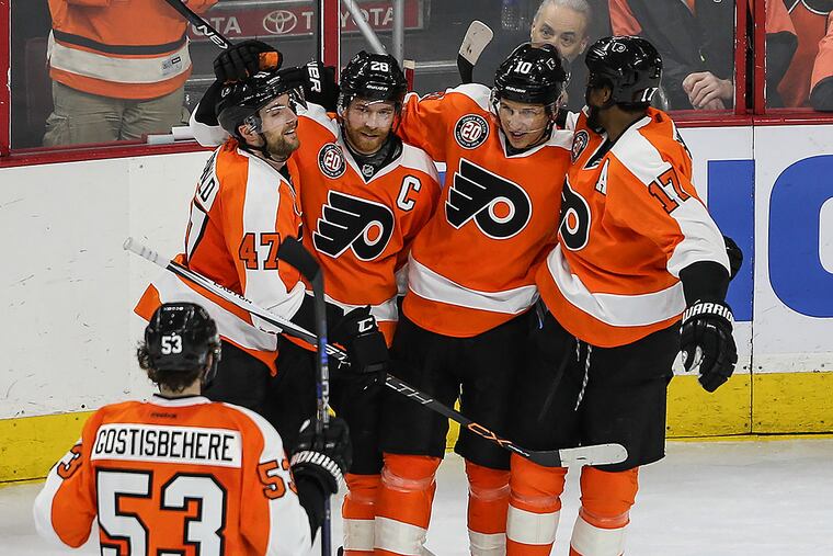 Brayden Schenn celebrates with teammates Andrew MacDonald, Claude Giroux and Wayne Simmonds after scoring his second goal against the Flames.