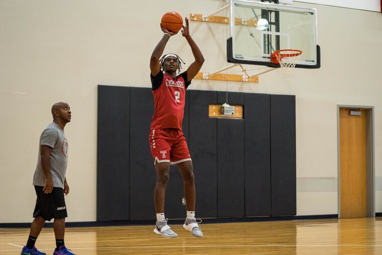 Temple basketball's Jahlil White shoots during an offseason workout as his trainer looks on.