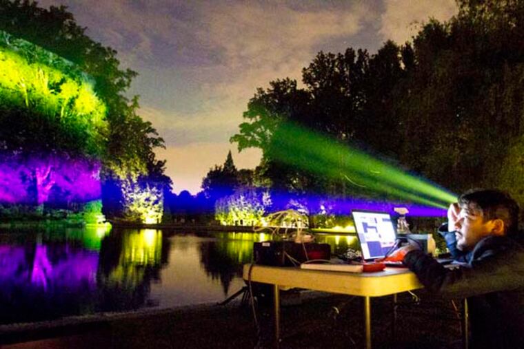 Ricardo Rivera works on some of the lights for "Nightscape," which premieres July 1 at Longwood Gardens. (CHARLES FOX/Staff Photographer)