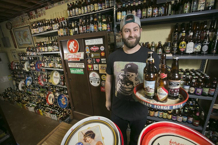 David Rosenblum with a portion of his father's collection of some 4,000 beer bottles, at the family home in Northeast Philadelphia.