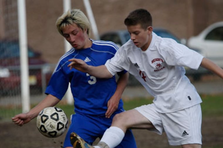 Gateway's Chris Norris (left) and Haddon Heights' Jake Roselle (right) go after the ball. Gateway plays Haddon Heights in the South Jersey boys' soccer semifinals on November 12, 2012. ( Michael S. Wirtz / Staff Photographer )
