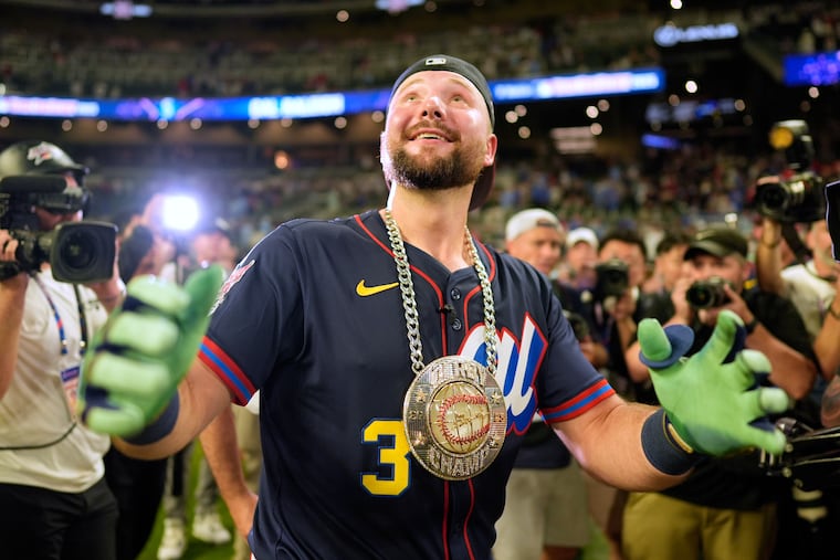 The Mariners' Cal Raleigh celebrates after winning the Home Run Derby last year in Atlanta.