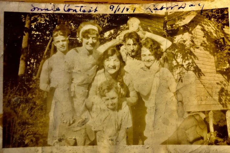 This family photo from 1927 is one of the few surviving images of Larry Saffron. He stands in the center holding his son, Stanley Mark Saffron, on his shoulders. The smiling woman in the center is Larry's sister, Ruth. His wife, Dorothy, stands on his right. The other people in the photo could not be identified.