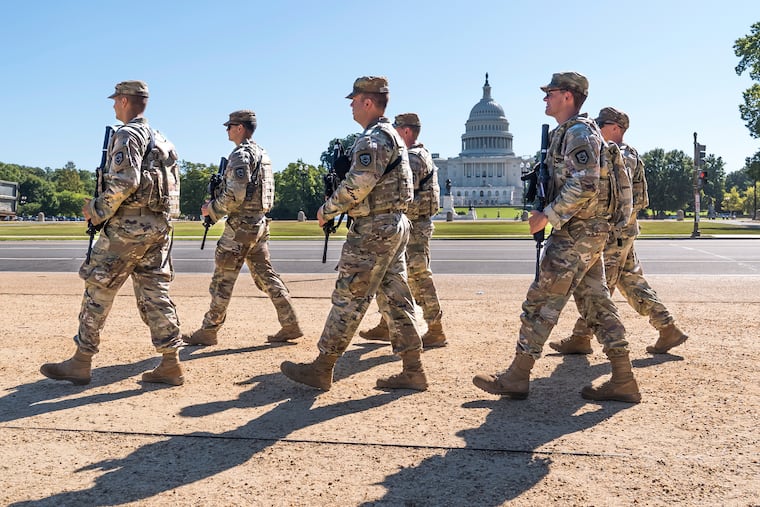 FILE - Armed National Guard soldiers from West Virginia patrol the Mall near the Capitol in Washington, as part of President Donald Trump's order to impose federal law enforcement in the nation's capital, Aug. 26, 2025.