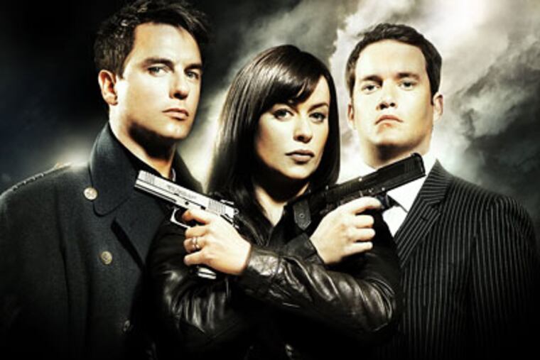 John Barrowman (left) plays Captain Jack Harkness, who likes guys and gals. With Eve Myles (center) and Gareth David-Lloyd.