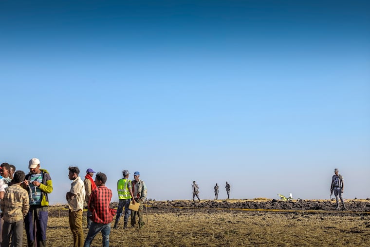 Rescuers search at the scene of an Ethiopian Airlines flight that crashed shortly after takeoff at Hejere near Bishoftu, or Debre Zeit, some 50 kilometers (31 miles) south of Addis Ababa, in Ethiopia Sunday, March 10, 2019. The Ethiopian Airlines flight crashed shortly after takeoff from Ethiopia's capital on Sunday morning, killing all 157 on board, authorities said, as grieving families rushed to airports in Addis Ababa and the destination, Nairobi.