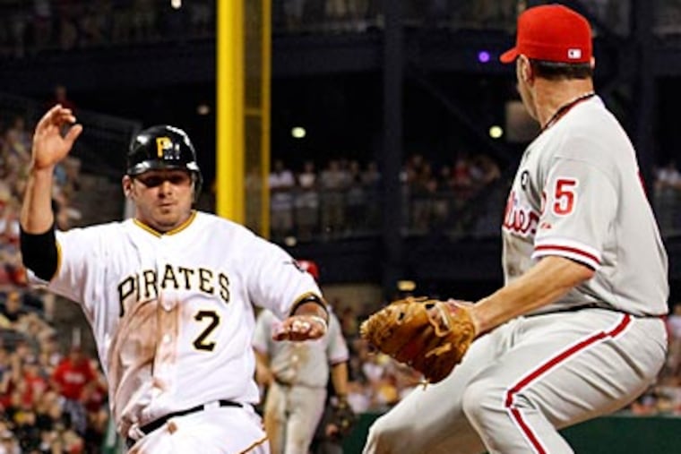 The Pirates' Brandon Wood scores after a wild pitch by Danys Baez in the eighth inning. (Gene J. Puskar/AP)
